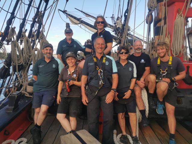 Photo of crew members posing aboard Endeavour tall ship