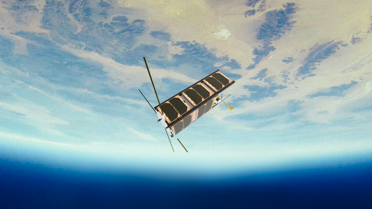 A cube satellite floats above earth in space 