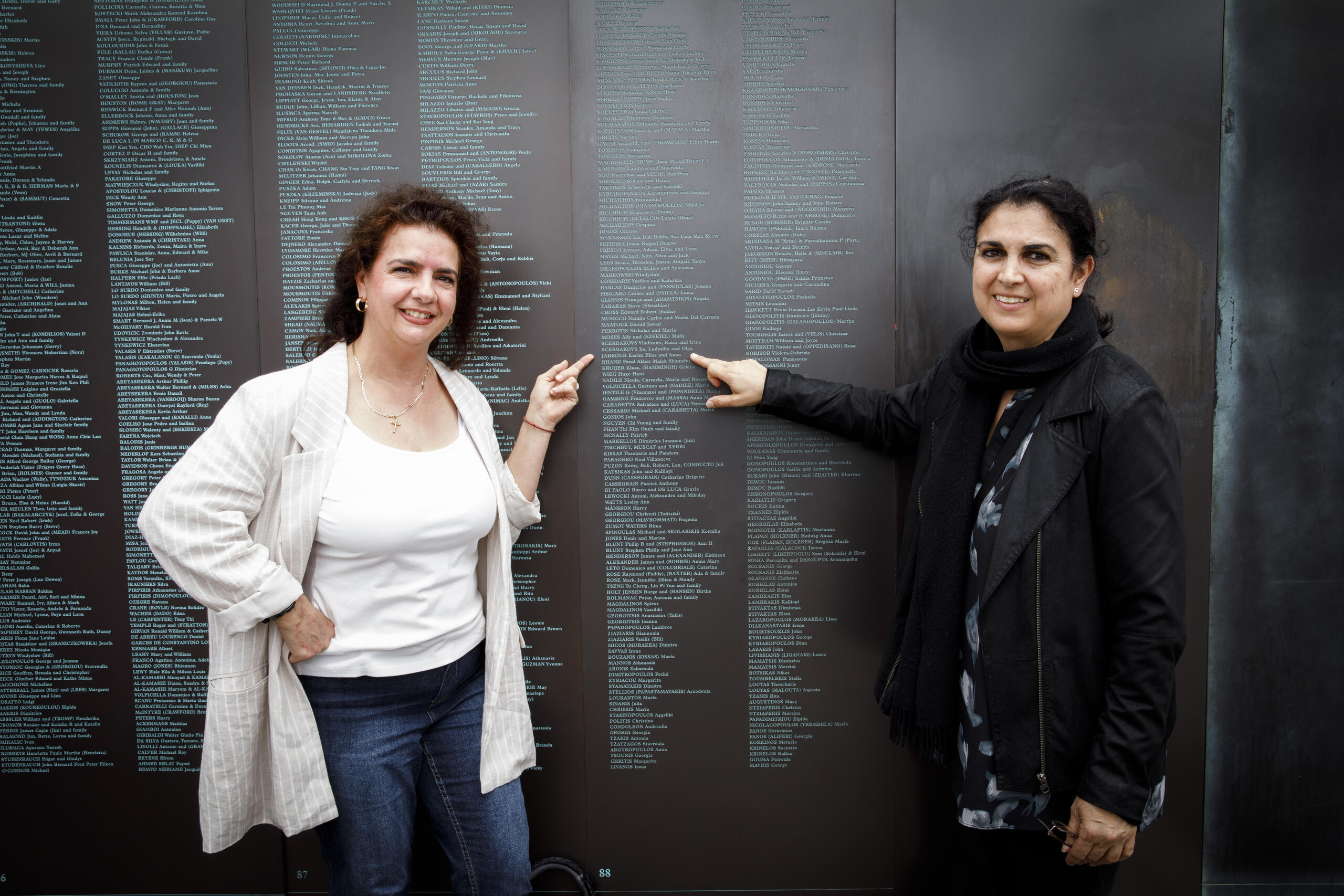 Two people in front of the National Monument to Migration